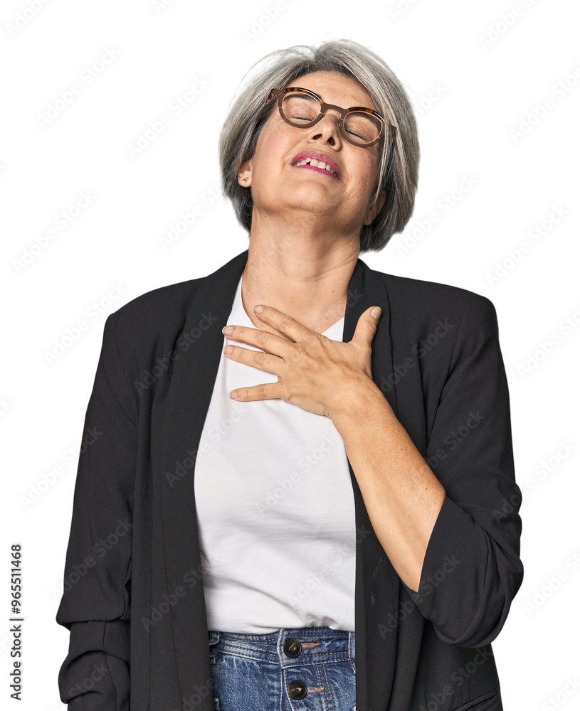 Caucasian mid-age female in business suit laughs out loudly keeping hand on chest. Caucasian mid-age female in business suit laughs out loudly keeping hand on chest.