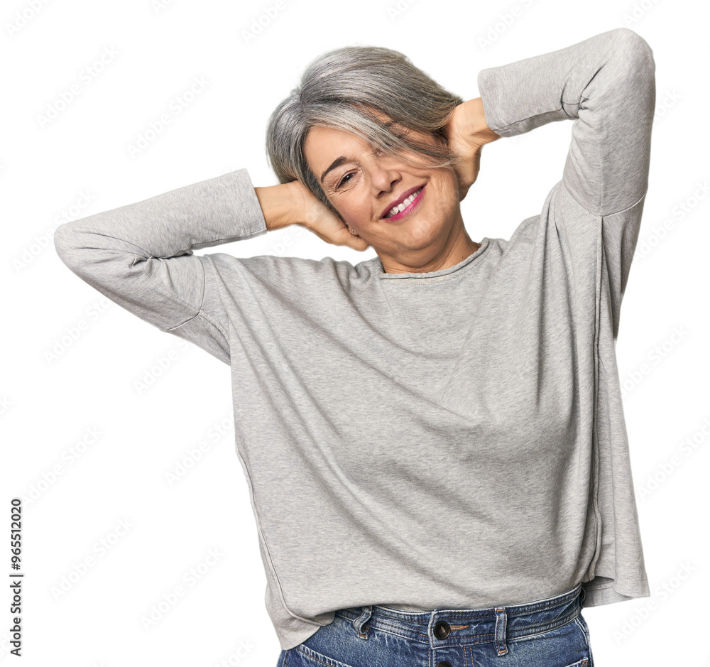 Caucasian mid-age female on studio background stretching arms, relaxed position. Caucasian mid-age female on studio background stretching arms, relaxed position.