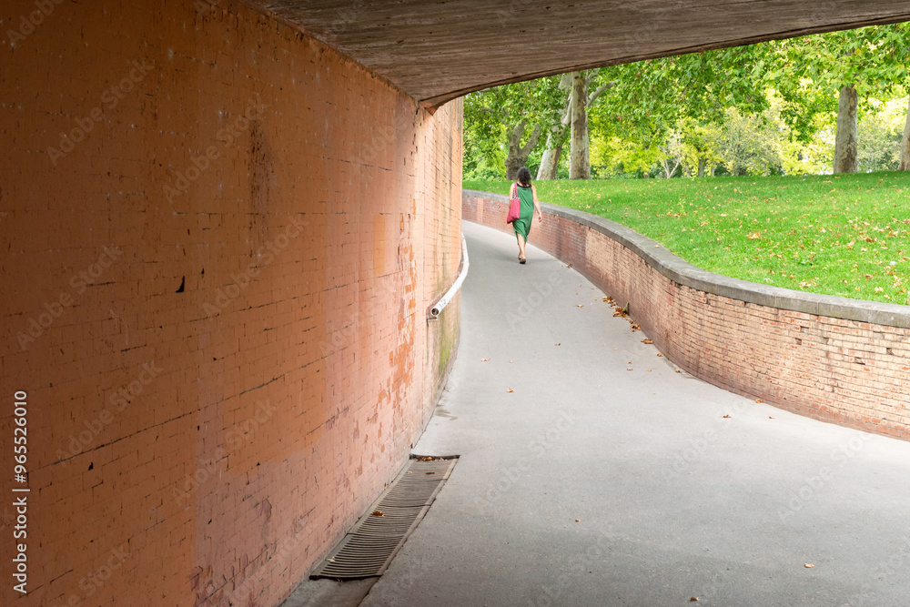 Obraz premium Woman walking along pedestrian walkway. Pamplona, ​​Navarra
