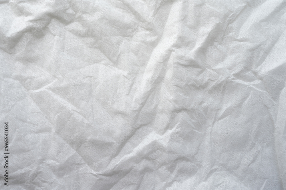 Full frame shot of crumpled tissue fabric texture and background. Tissue fabric is slightly rough and crisp in texture. Full frame shot of crumpled tissue fabric texture and background. Tissue fabric is slightly rough and crisp in texture.