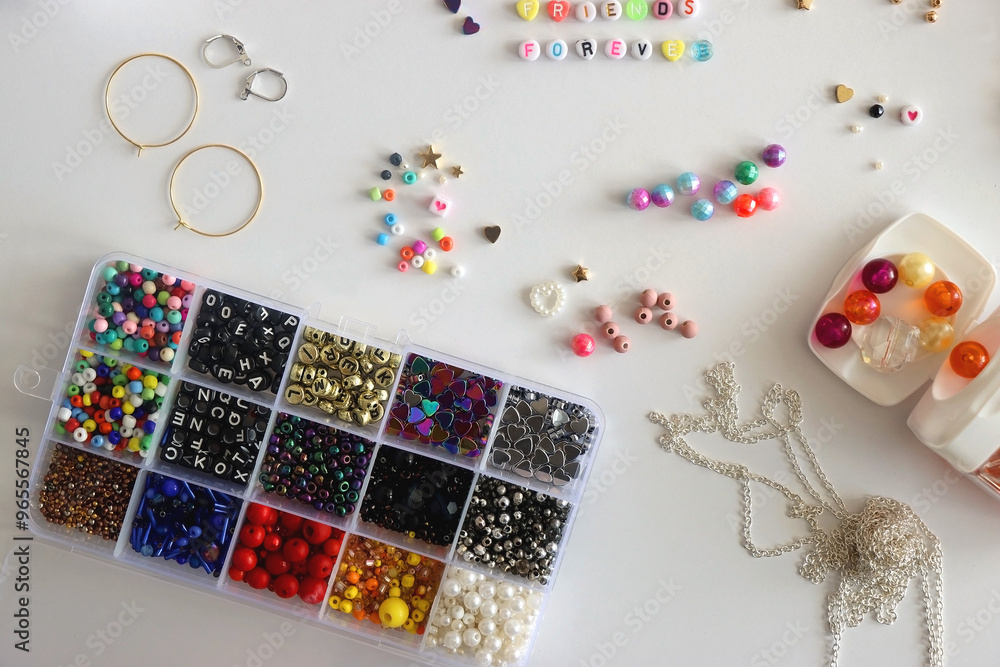 Friends forever written with colorful beads. Jewelry making supplies on the table. Making friendship bracelets concept. Flat lay.