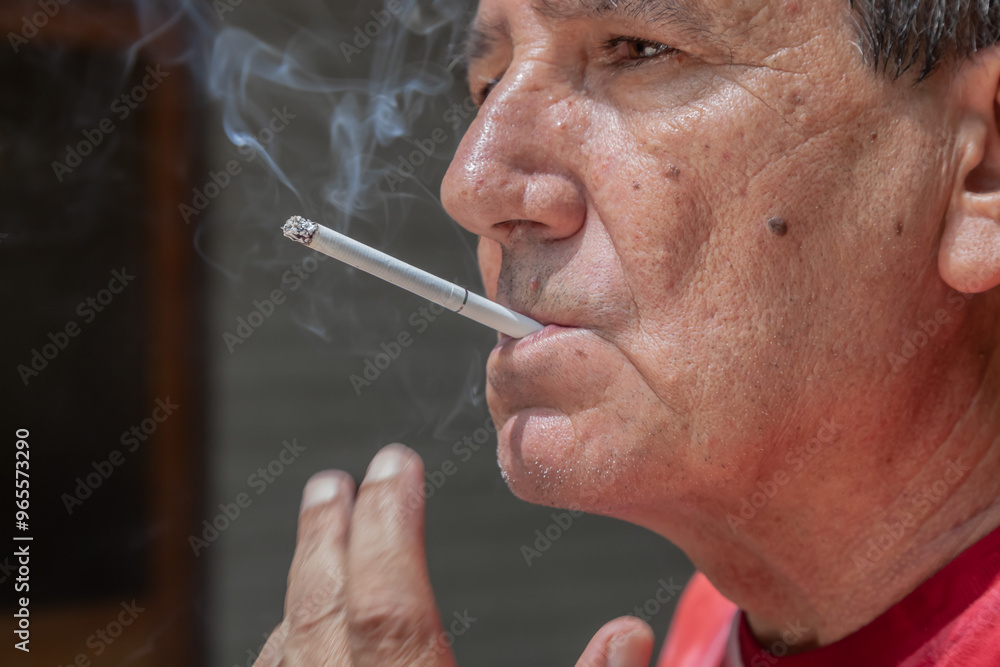 Fototapeta premium Smoker lighting a cigarette with lighter
