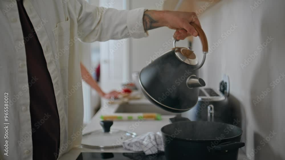 Man hands pouring water cooking at home closeup. Happy couple preparing food Man hands pouring water cooking at home closeup. Happy couple preparing food