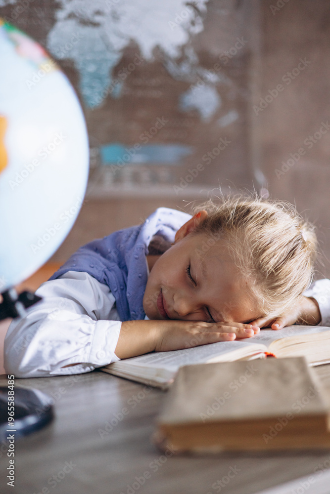 Schoolgirl sleeping at the desk in class Schoolgirl sleeping at the desk in class
