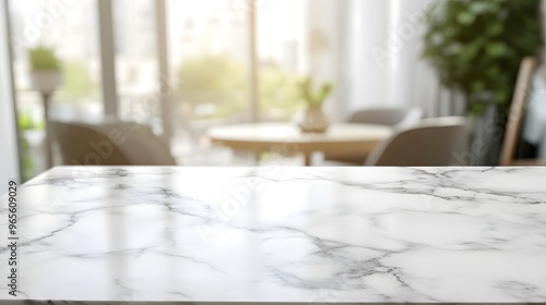 Close-up of a white marble countertop with a blurred background of a living room with a round table and chairs.