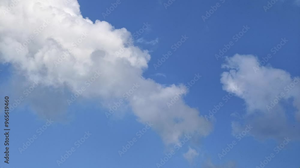 Timelapse of cumulus white clouds moves in the blue sky. The background of calm clouds changes shape in cloudy space. Natural background, time-lapse, copy space. 4K. Timelapse of cumulus white clouds moves in the blue sky. The background of calm clouds changes shape in cloudy space. Natural background, time-lapse, copy space. 4K.