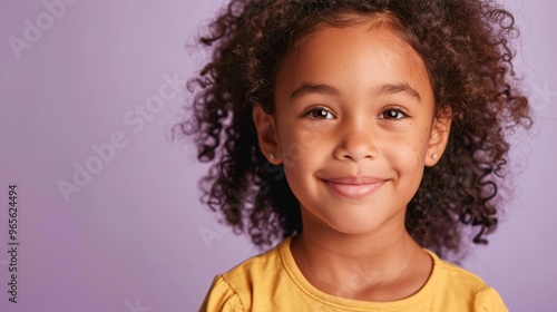 Radiant pupil smiling in front of a soft purple backdrop, ideal for school-themed imagery