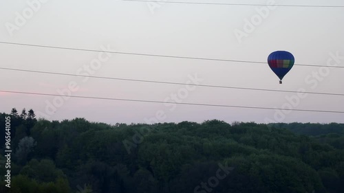 Hot air balloon flying behind power lines