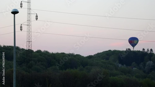 Hot air balloon behind power grid lifting