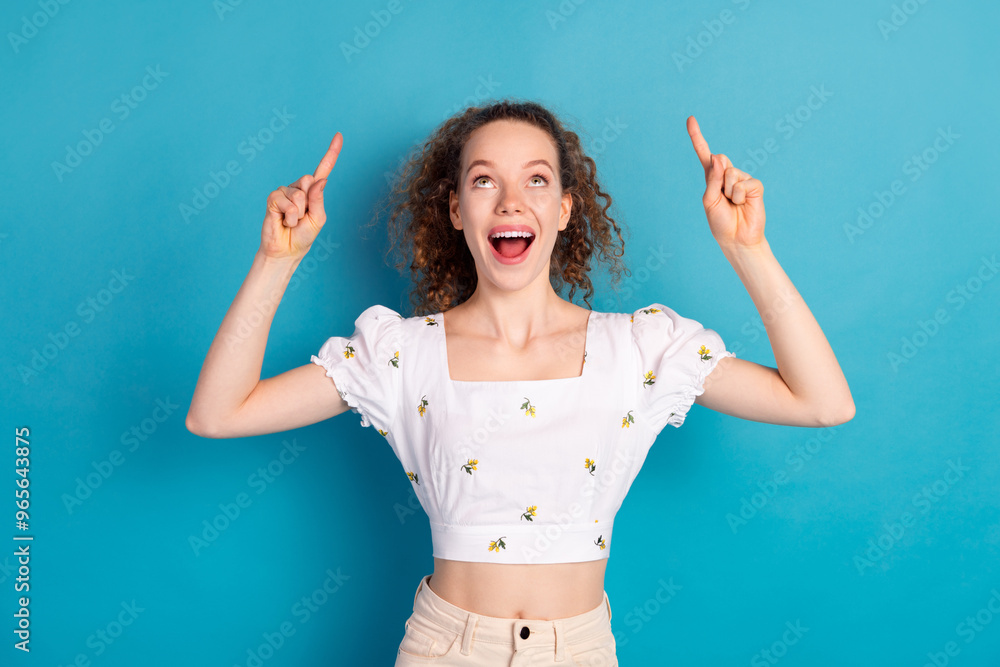 Fototapeta premium Photo portrait of attractive young woman look point up empty space dressed stylish white clothes isolated on blue color background