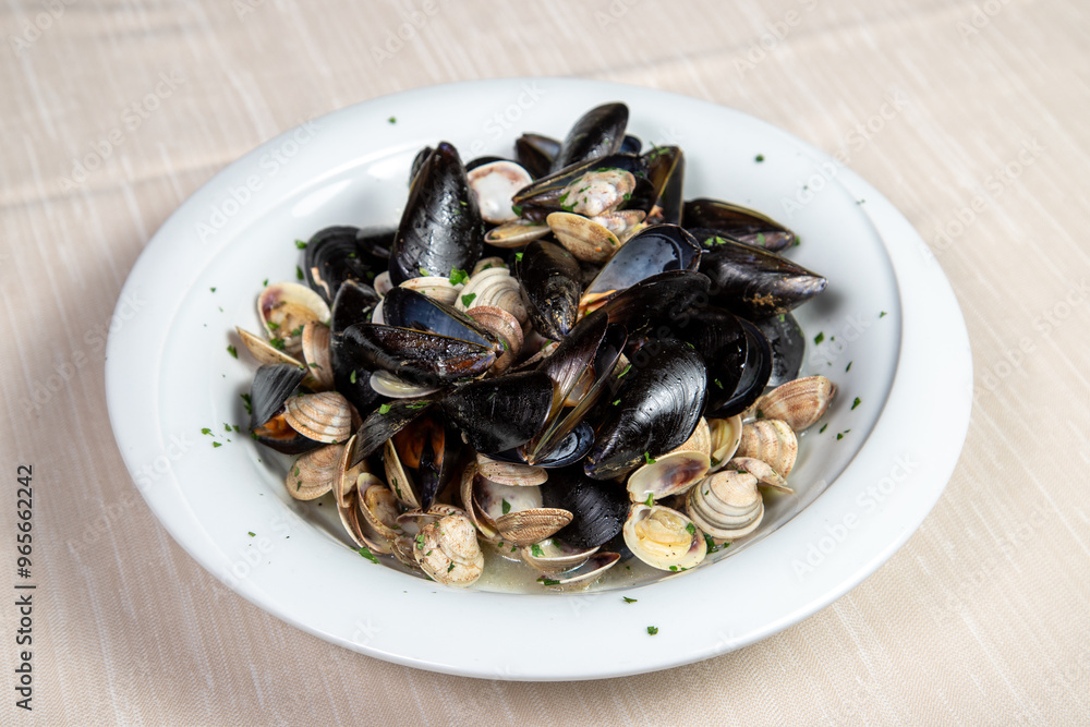 Mussels and clams soup in a withe dish. Mussels and clams soup in a withe dish.