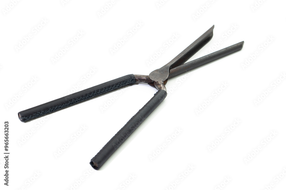 Ancient barber pair of tongs on white background. Vintage curling iron. beauty concept Ancient barber pair of tongs on white background. Vintage curling iron. beauty concept