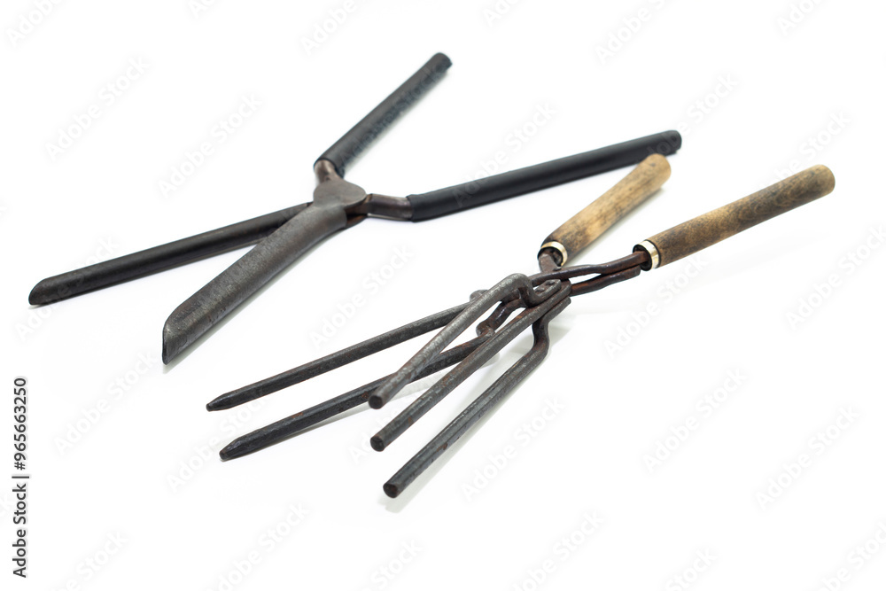 Ancient barber pair of tongs on white background. Vintage curling iron. beauty concept Ancient barber pair of tongs on white background. Vintage curling iron. beauty concept