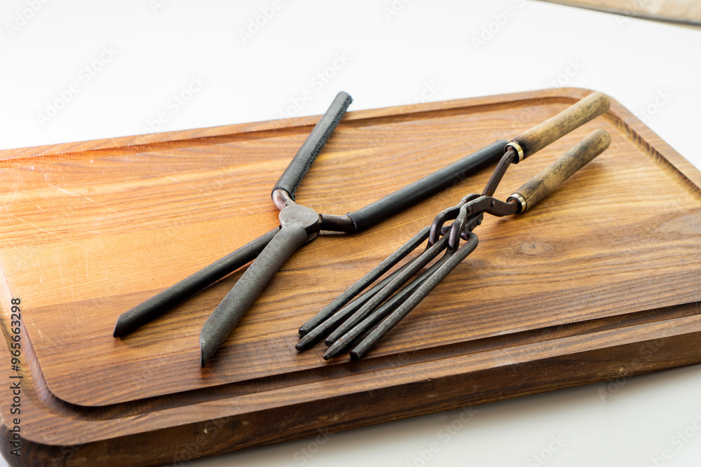 Obraz premium Ancient barber pair of tongs on white background. Vintage curling iron. beauty concept