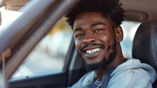 Afro person grinning while seated in the driver's seat