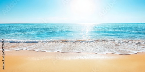 Fototapeta Naklejka Na Ścianę i Meble -  A serene beach landscape with gentle waves and a bright sun illuminating the clear blue ocean on a peaceful day.