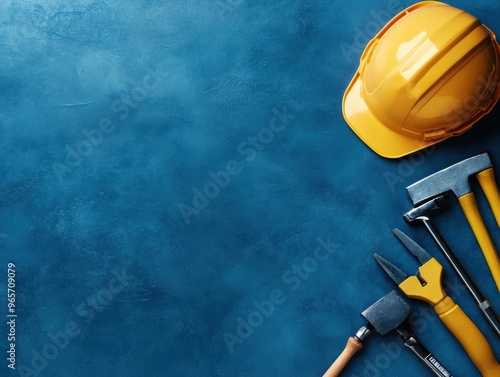 A collection of construction tools and a safety helmet on a blue background, perfect for construction or DIY projects.