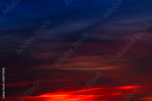 Background of the dawn sky with sunlight shining through the clouds creates a beautiful and fascinating color. 