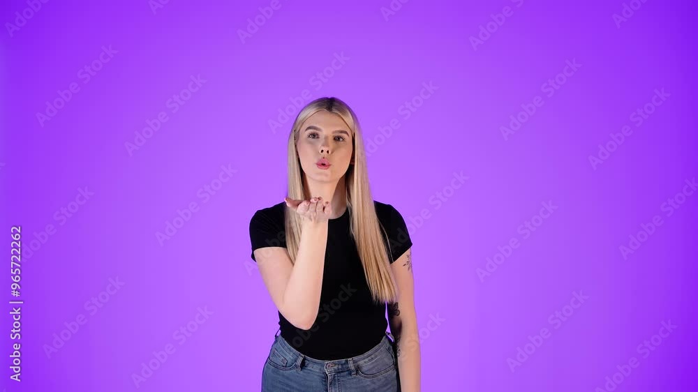 Portrait Of Pretty Blonde Woman Blowing Kiss Gesture, Purple Background, Studio Shot Portrait Of Pretty Blonde Woman Blowing Kiss Gesture, Purple Background, Studio Shot
