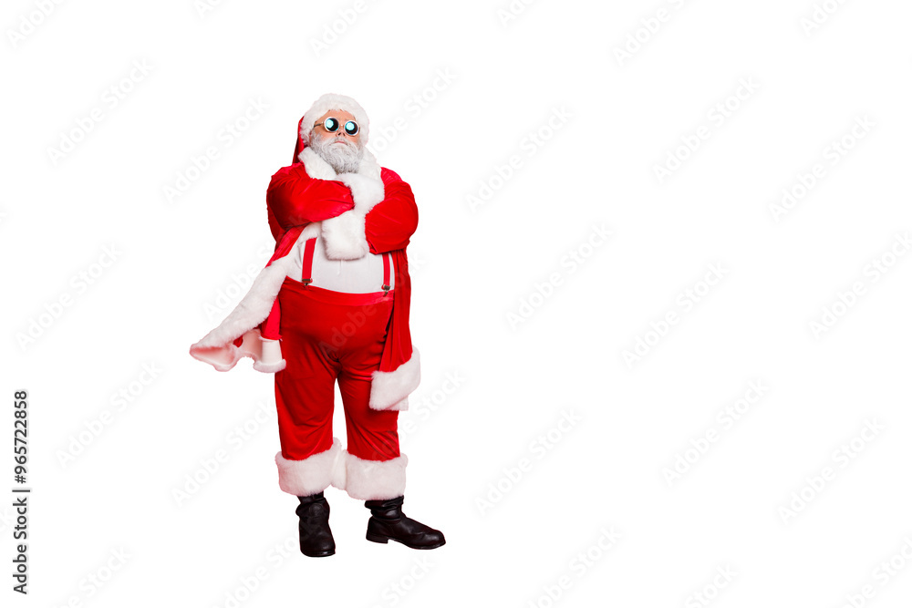 Full length photo of minded fat overweight santa claus bad guy with his hands crossed big abdomen choose naughty kids wear eyeglasses isolated over red background Full length photo of minded fat overweight santa claus bad guy with his hands crossed big abdomen choose naughty kids wear eyeglasses isolated over red background