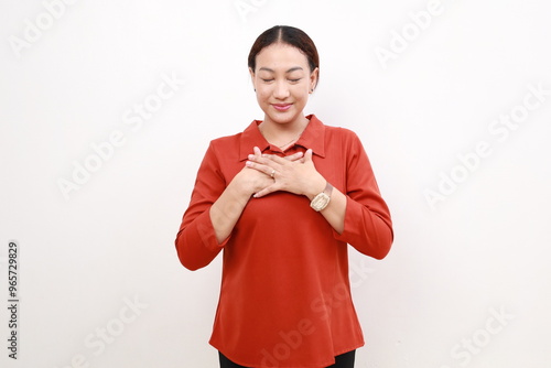 Photos Asian business woman smiling with hands on chest with closed eyes and grateful g