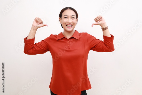 Cute sad asian girl showing thumbs down and making sad facial expression isolated on white background photo