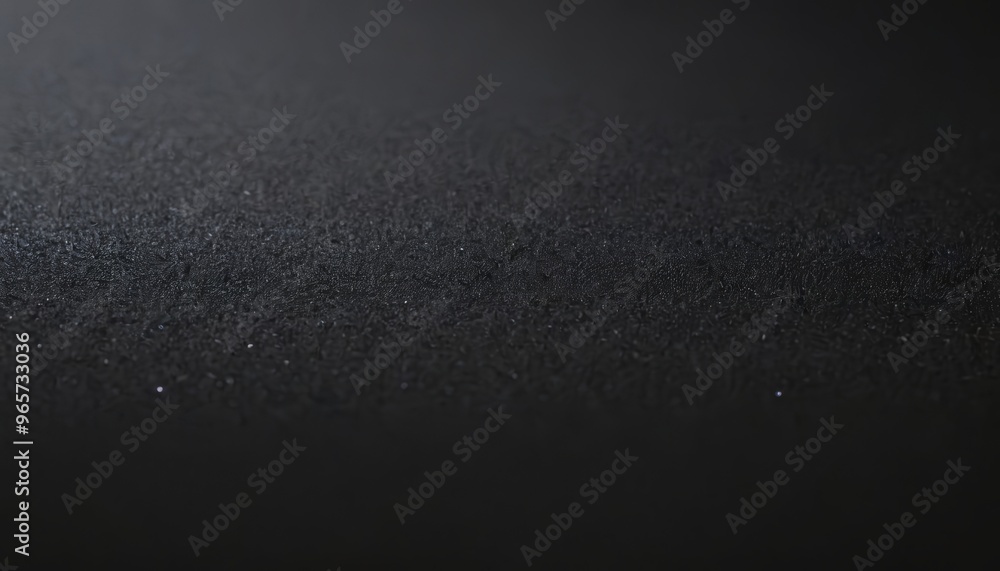 Close-up abstract texture of a black surface with a grainy pattern. Close-up abstract texture of a black surface with a grainy pattern.