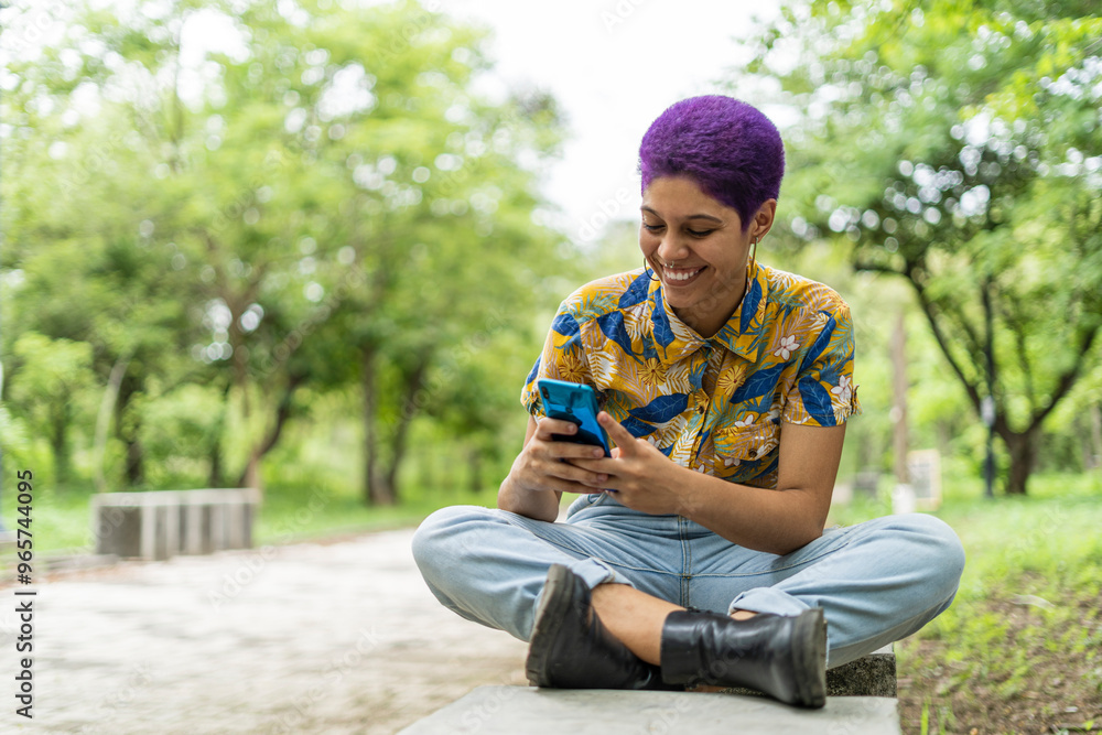 LGBTQ woman smiling while using her phone LGBTQ woman smiling while using her phone