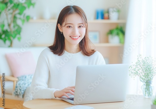 Asian woman using laptop computer.