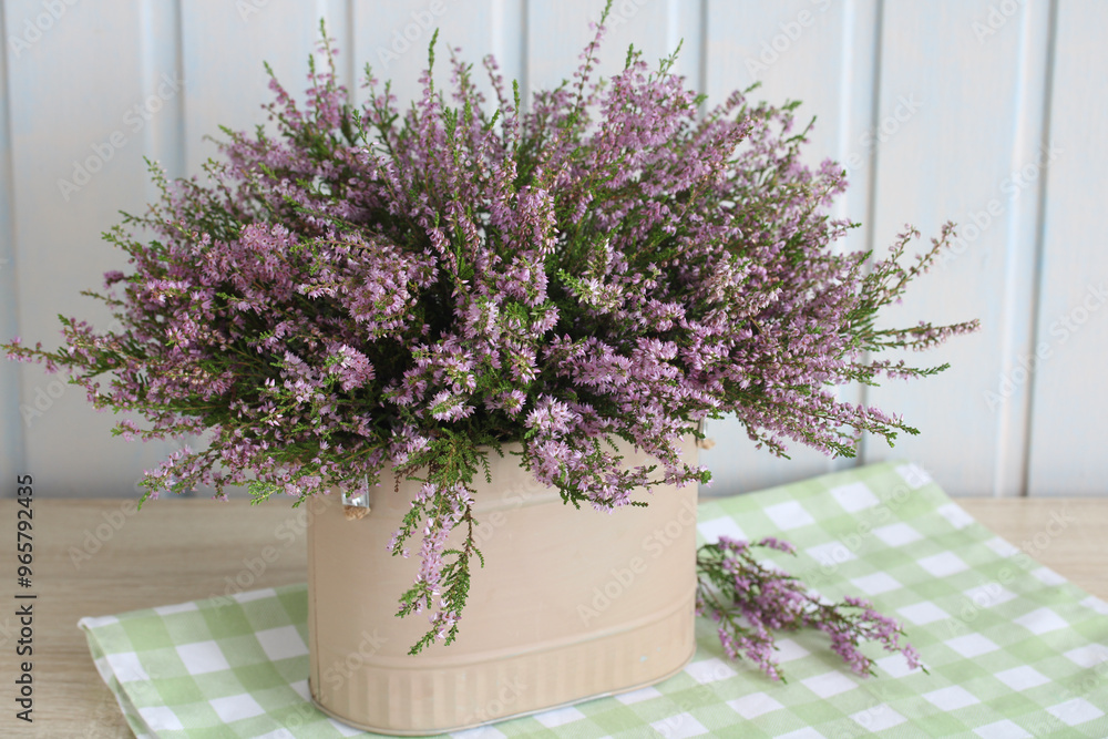 still life with a bouquet of heather on the table in the cottage. summer time, forest heather, a lush bouquet of flowering branches. still life with a bouquet of heather on the table in the cottage. summer time, forest heather, a lush bouquet of flowering branches.