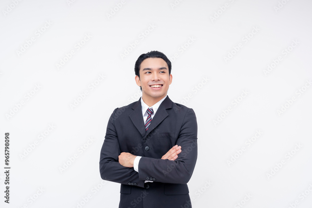Candid portrait of an optimistic young asian business executive in a fashionable suit and tie. Arms crossed, standing confidently. Isolated on a white background. Candid portrait of an optimistic young asian business executive in a fashionable suit and tie. Arms crossed, standing confidently. Isolated on a white background.