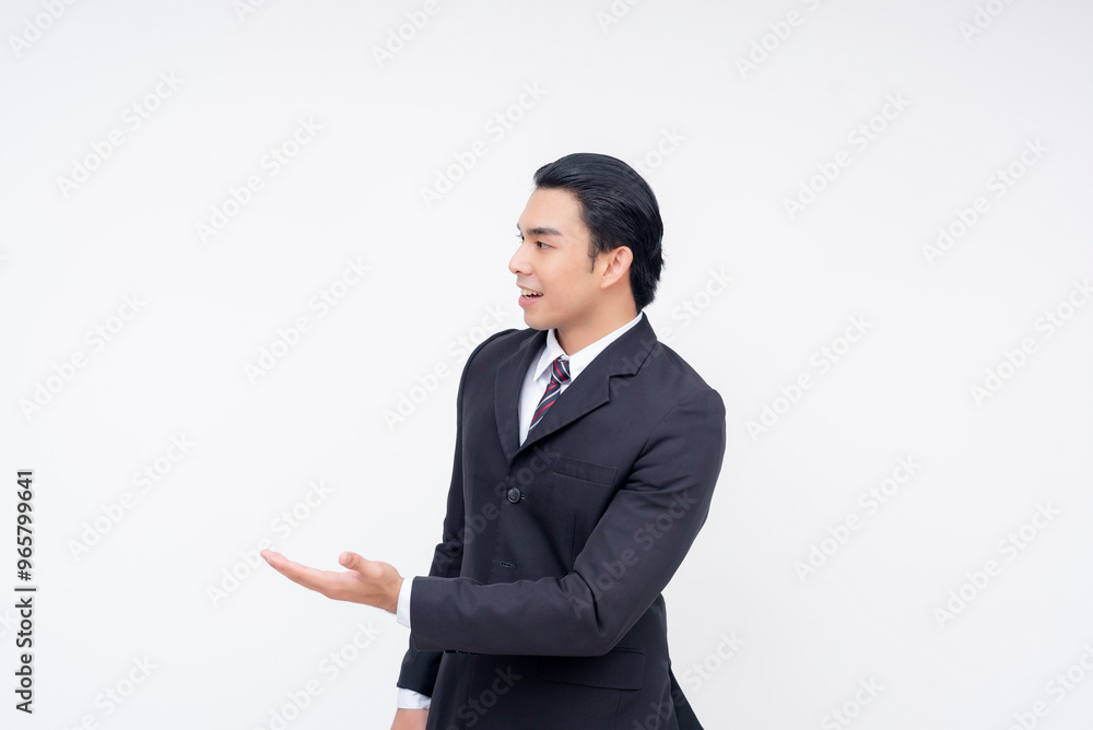 Portrait of an optimistic young asian business executive in a fashionable suit and tie presenting something to his left. Isolated on a white background. Portrait of an optimistic young asian business executive in a fashionable suit and tie presenting something to his left. Isolated on a white background.