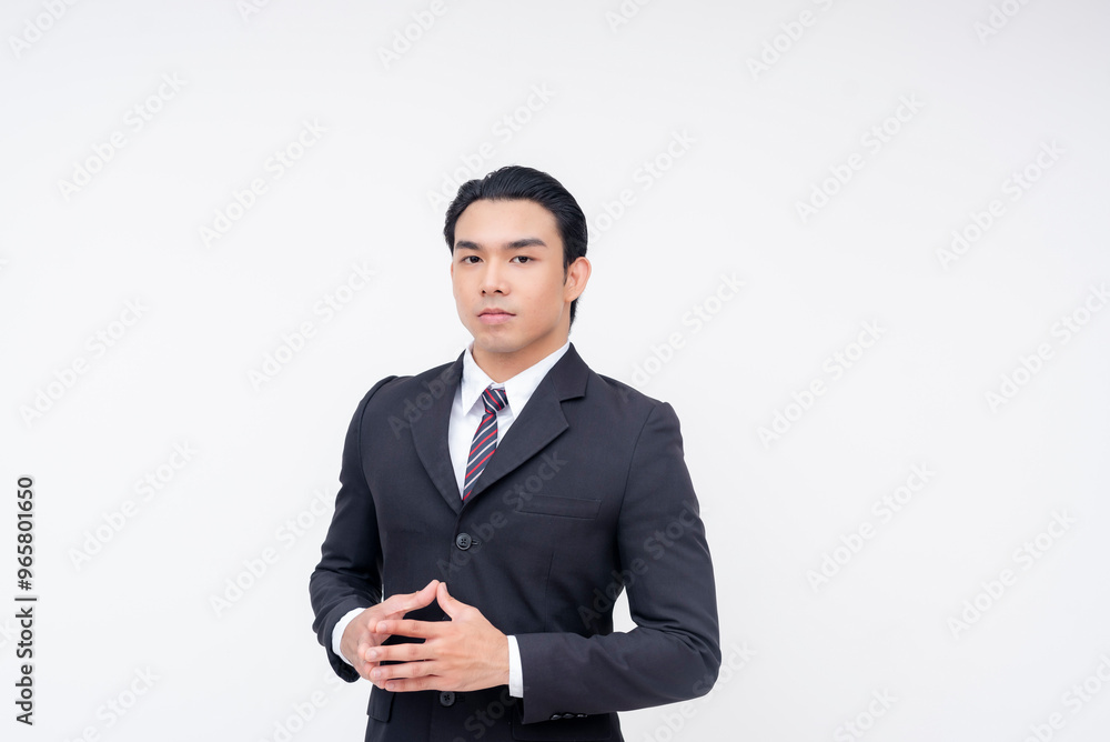 Portrait of a serious and composed young asian businessman in a suit and tie, hands together as if to make a proposal. Portrait of a serious and composed young asian businessman in a suit and tie, hands together as if to make a proposal.