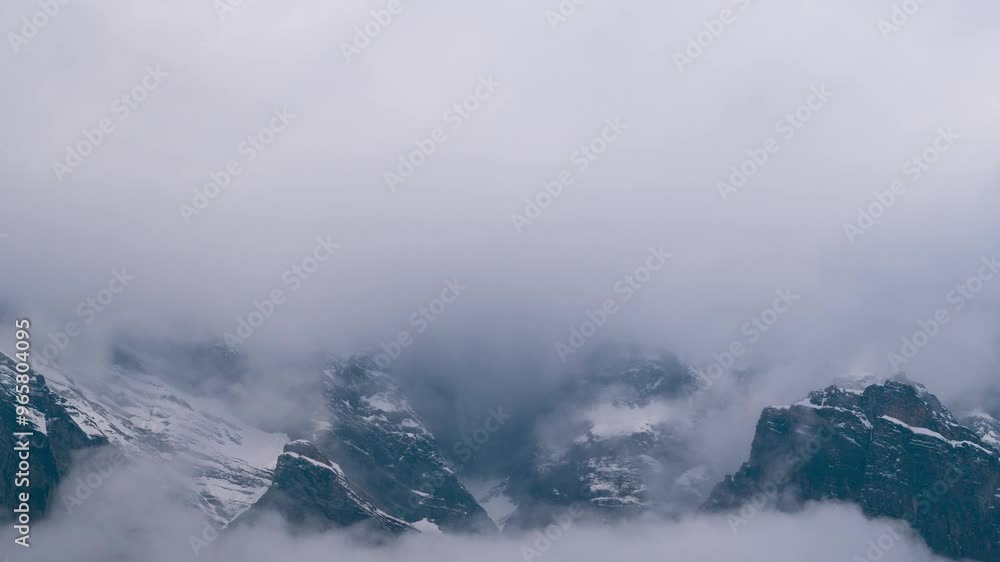 Storm clouds roll over snow mountains during stormy day in winter at Lahaul, Himachal Pradesh, India. 4K Zoom in Time Lapse of dark clouds rolling over mountains. Nature landscape. Storm clouds roll over snow mountains during stormy day in winter at Lahaul, Himachal Pradesh, India. 4K Zoom in Time Lapse of dark clouds rolling over mountains. Nature landscape.