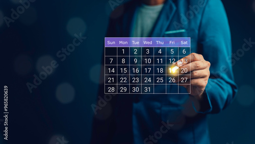 Calendar on the virtual screen interface. Businessman manages time for effective work. Highlight appointment reminders and meeting agenda on the calendar. Time management concept.