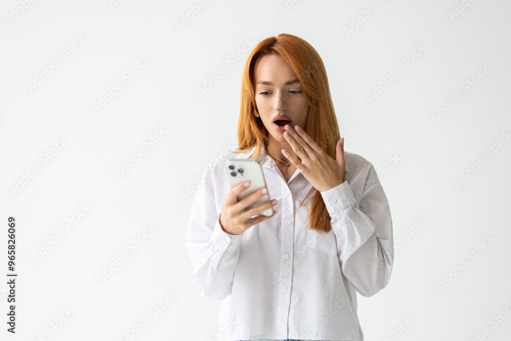 Portrait of a shocked businesswoman using mobile phone over white background Portrait of a shocked businesswoman using mobile phone over white background
