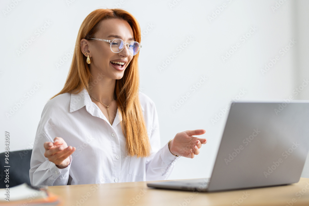 Business woman talking on a video call in a coworking office. Business woman talking on a video call in a coworking office.