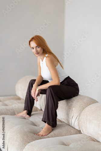 Calm young woman relaxing on comfortable couch at home