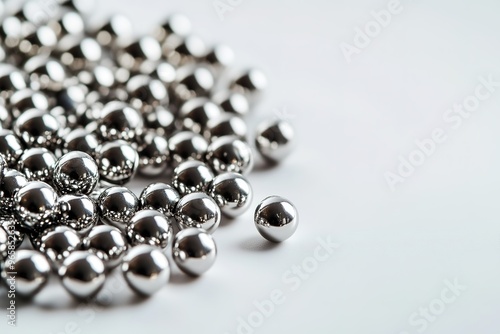 Shiny metal spheres scattered on white surface
