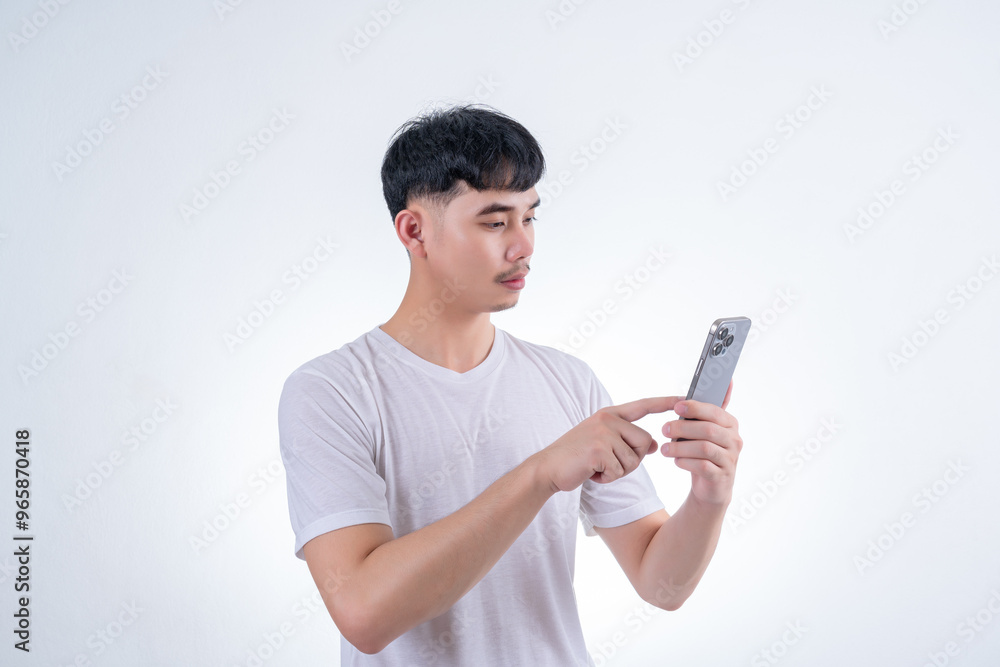 Handsome Asian man using smartphone on white background. Concept for advertising, finance business, communication, technology advancement and online shopping. Handsome Asian man using smartphone on white background. Concept for advertising, finance business, communication, technology advancement and online shopping.