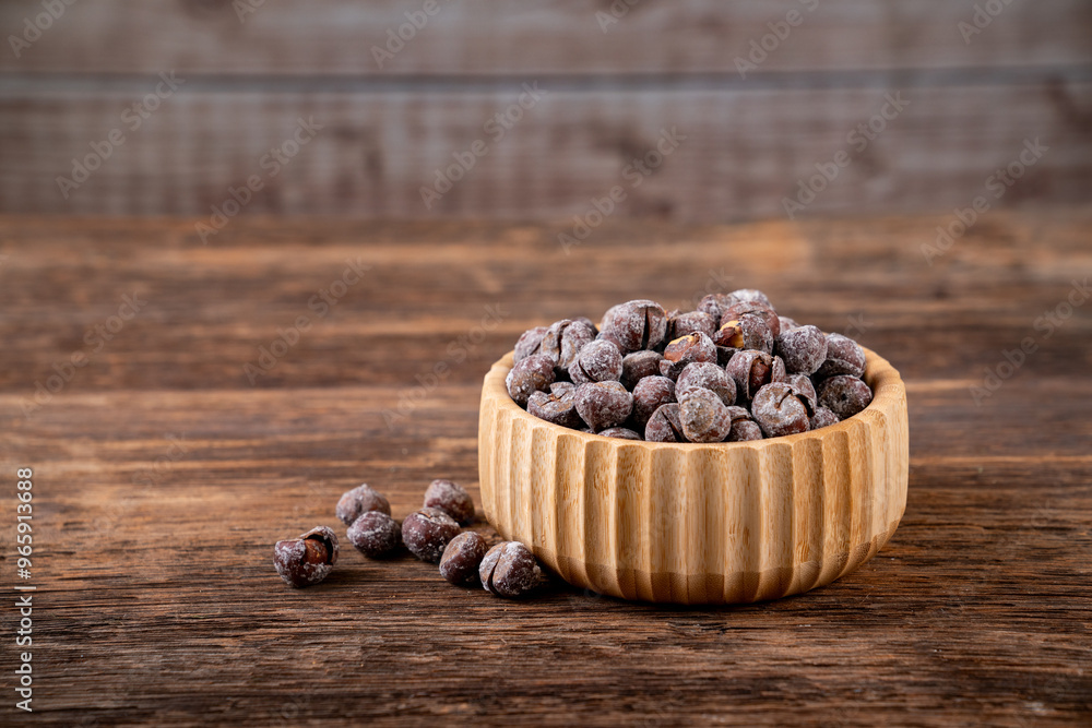 Roasted hazelnuts in shell on old wooden table Roasted hazelnuts in shell on old wooden table