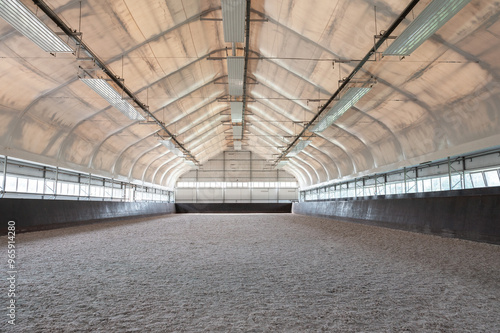 Empty horse riding arena indoor without people