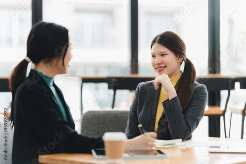 Engaging conversation between two women in modern office setting