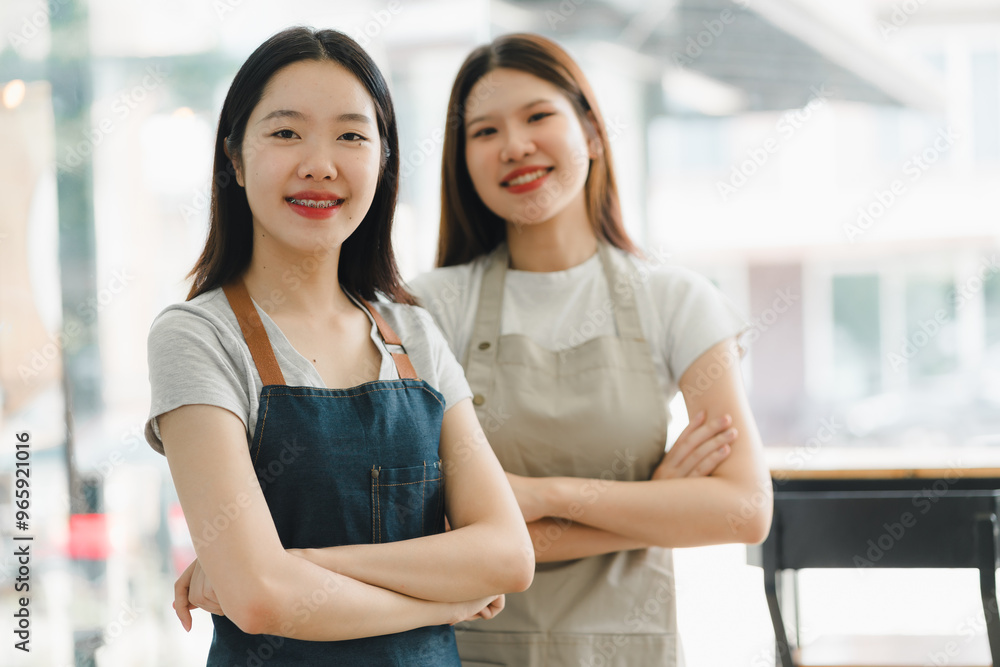 Fototapeta premium Empowered women in aprons smiling confidently in cafe setting