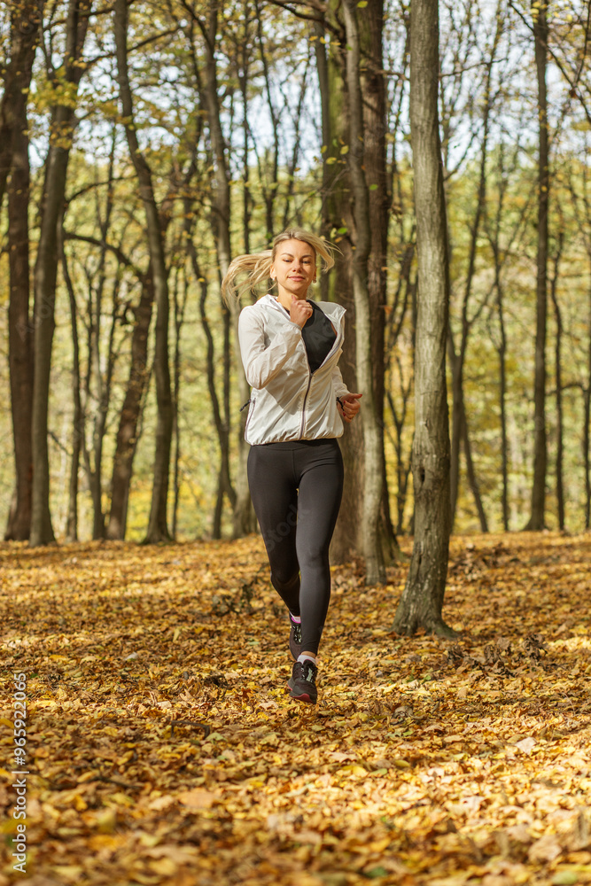 Woman running through autumn forest in activewear. Mental health. Woman running through autumn forest in activewear. Mental health.