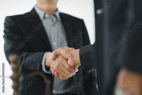 Business handshake symbolizes partnership and agreement in professional setting.