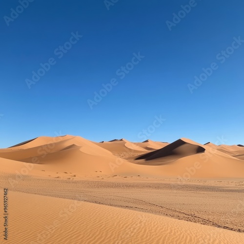 Expansive desert landscape with clear blue sky and rolling sand dunes.