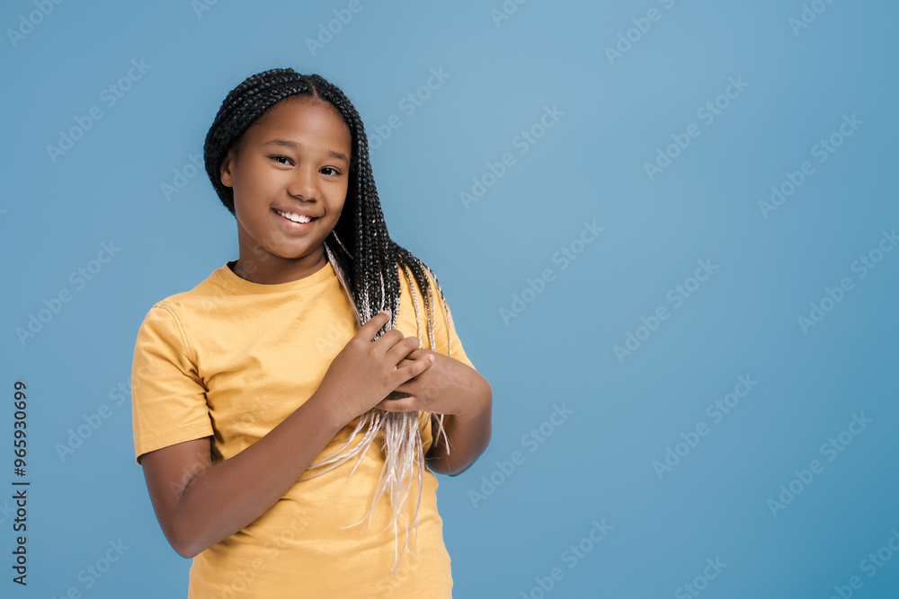 Portrait of smiling African American girl with stylish hair wearing casual t shirt looking at camera Portrait of smiling African American girl with stylish hair wearing casual t shirt looking at camera