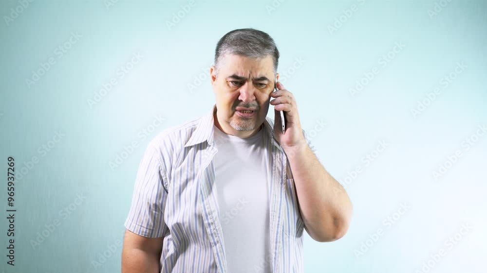 A man swears on the phone. He screams and gestures. The concept of difficulties in communication, misunderstandings, differences of opinion, emotional burnout. A man swears on the phone. He screams and gestures. The concept of difficulties in communication, misunderstandings, differences of opinion, emotional burnout.