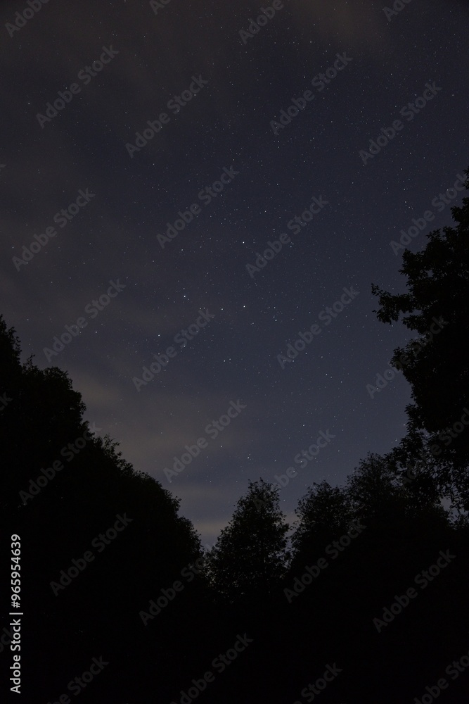 Fototapeta premium Evening sky with cassiopeia and clouds